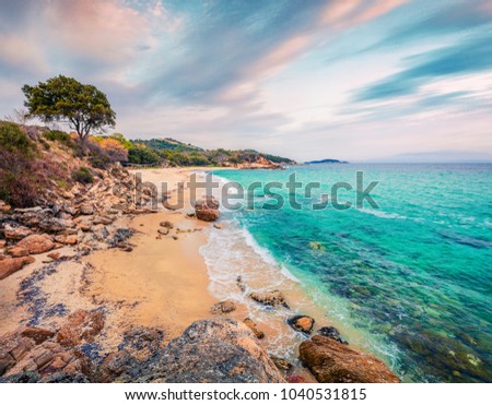 Sunny summer seascape of Aegean Sea. Beautiful sunrise on Cuba Beach, Olimpiada village location, Greece, Europe. Beauty of nature concept background. 