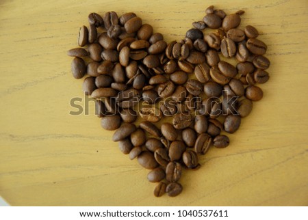 coffee beans formed hearts on a wooden table
