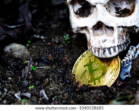 Close up of Skull biting bitcoin on the ground  Royalty-Free Stock Photo #1040538685