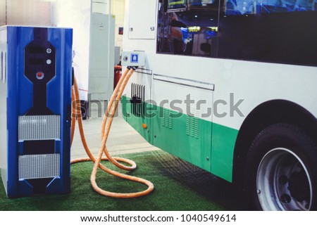 Details of electric vehicle charging city bus transport. Green and renewable energy sources.  Royalty-Free Stock Photo #1040549614