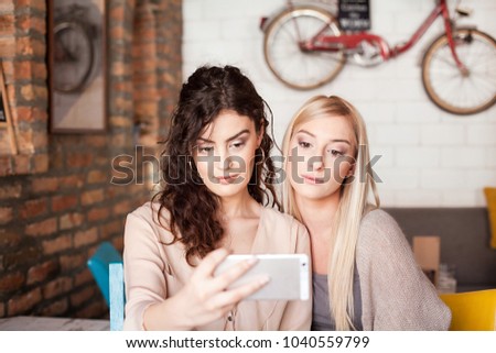 Women In Cafe Taking Selfie Using Smart Phone
