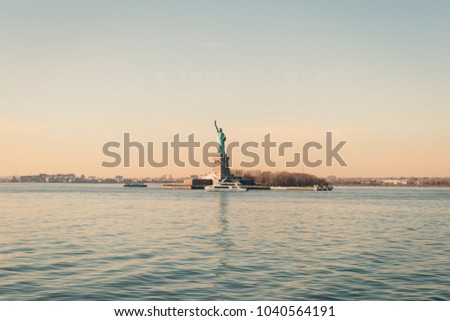 Amazing View of Statue of Liberty in New York City on the Background of Colorful Dawn Sky, Free Space for Text