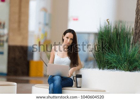 Cute girl with laptop in Mall