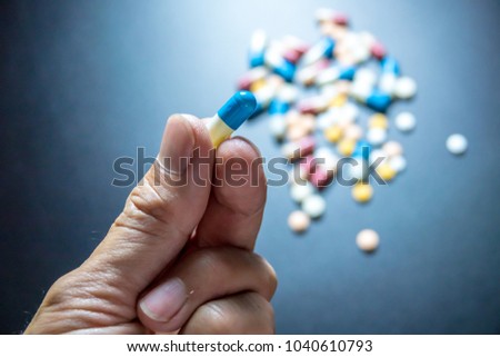 Medicine on hand with colorful medicine black background