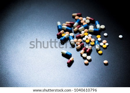 Top view of colorful medicine on black backgroud with copy space for text. 