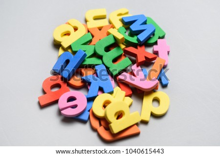 A lot of colorful letters of polystyrene on a white background.