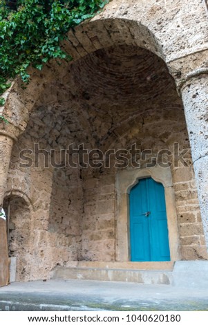 Blue door of a monastery, the color of the wood playing nicely with the color of the sandstone wall