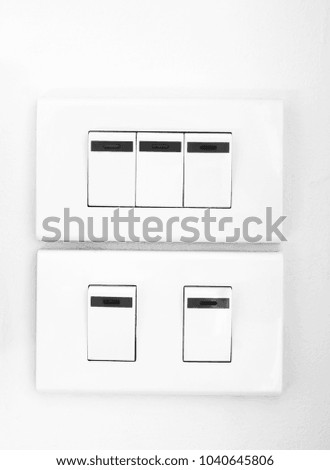 White light switch on concrete wall