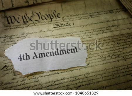 4th Amendment newspaper headline on a copy of the US Constitution                               Royalty-Free Stock Photo #1040651329