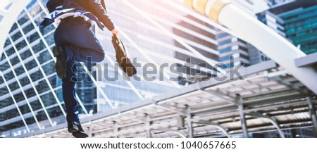Carear Jumping running business man in front of buildings Royalty-Free Stock Photo #1040657665