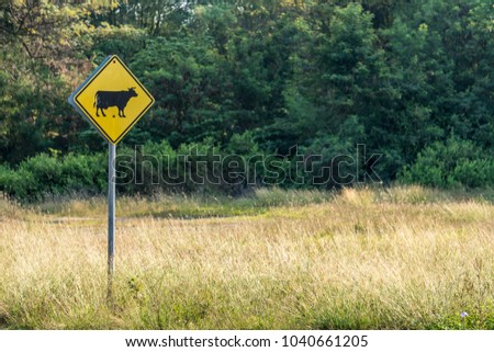 Traffic signs warning the cattle cross the road. Located in a rural area in Thailand.