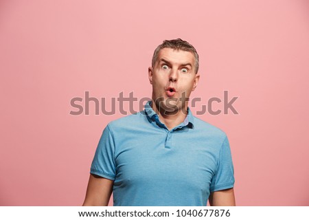 Wow. Attractive male half-length front portrait on pink studio backgroud. Young emotional surprised bearded man standing with open mouth. Human emotions, facial expression concept. Trendy colors Royalty-Free Stock Photo #1040677876