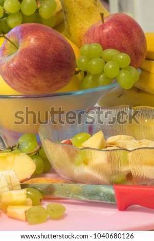 Many fresh fruits as ingredients for the vegan and healthy cuisine - text on knife: German for "stainless steel"