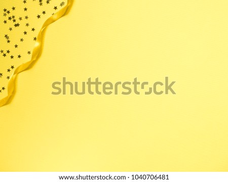 Yellow tape along the yellow background. Confetti star framing
