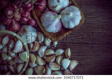 Thai herbs garlic and onion on wooden floor