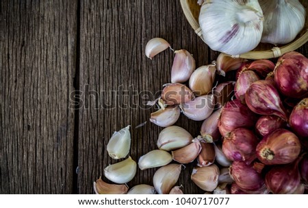 Thai herbs garlic and onion on wooden floor