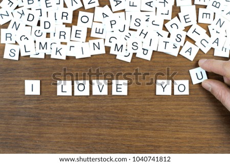 "I Love You" writing with plastic letters on a wooden table. Conceptual image.