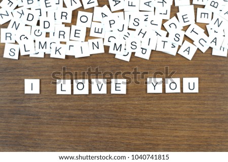 "I Love You" writing with plastic letters on a wooden table. Conceptual image.