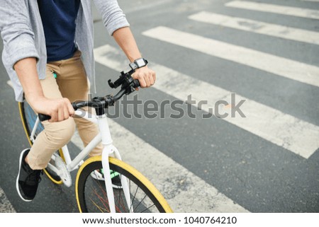 Cropped image of bicycle rider on pedestrian crossing