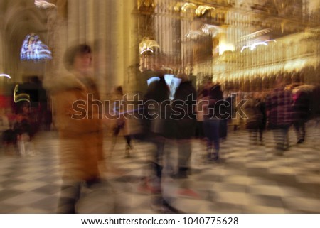 ghostly figures in the cathedral,Toledo, Impressionist photo at very low speed of blurred human figures in movement, camera trepidation to give a sense of unreality,mystery,spirituality,faith,