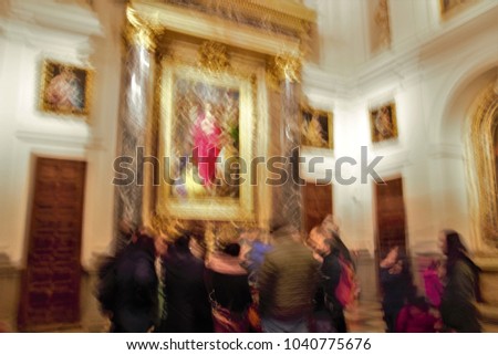 ghostly figures in the cathedral, looking at a picture,Impressionist photo at very low speed of blurred human figures in movement, camera trepidation on purpose to give a sense of unreality, mystery
