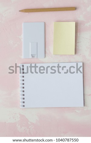 Blank white plastic wafer usb card mockup lying,Visiting flash drive namecard mock up.  Flat wallet credit stick adapter. pen,white notebook on the pink background