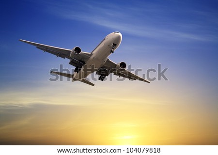Boeing 777  landing at sunset, just before touch down, from rear. . Royalty-Free Stock Photo #104079818