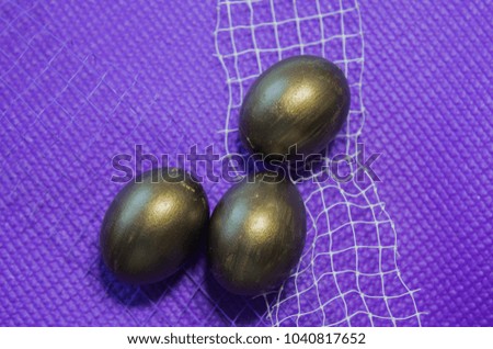Easter. golden eggs. eggs with a feather. good easter. The inscription on white and on a purple background. Easter eggs. Easter pictures.