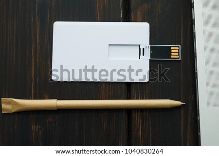 Photo of blank stationery set on wood background. Envelope, business cards, pen usb flash card. Corporate identity template. Responsive design mockup.