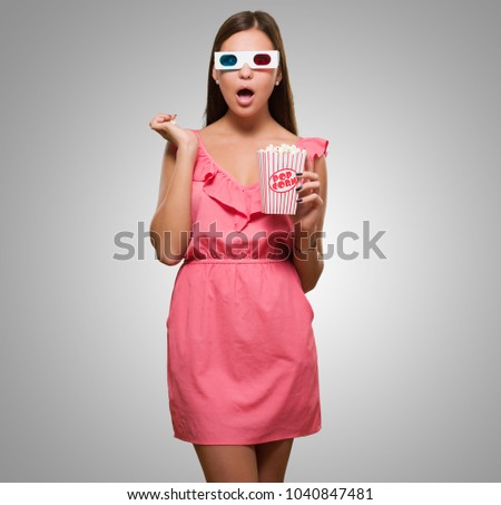 Shocked Woman Watching 3d Movie against a grey background