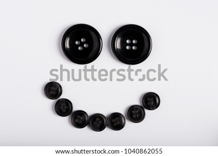 Smiling of buttons on white background, top view.
