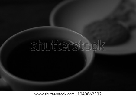 coffee in white cup and a cookie on a plate (black and white ), perfect for coffee break