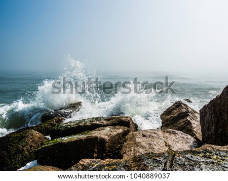 Waves crashing into the rocks on a jetty in Port Aransas, Texas