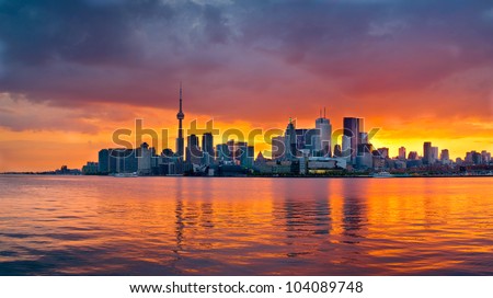 The Toronto skyline as the sun sets behind it