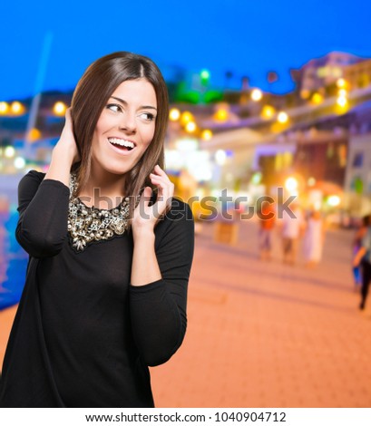 Beautiful young woman smiling at a port