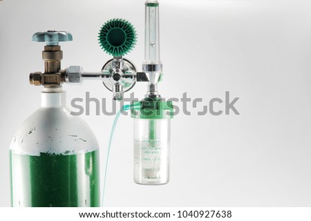 Equipment medical Oxygen tank and Cylinder Regulator gauge.Control pressure oxygen gas for care a patient respiratory disease and emergency CPR at Hospital, Close up focus on black background. Royalty-Free Stock Photo #1040927638
