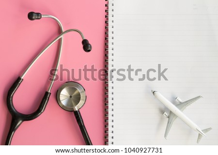 Close up of Stethoscope and Jet Airplane Model on Notebook. Idea Concept for Sick Passengers on the Plane, Life Travel Insurance, Patient Registration of Doctor or Medical Flight. 