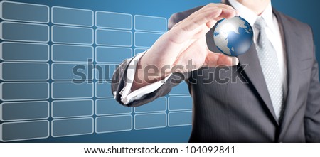 Business man showing digital globe with touch screen icons in background