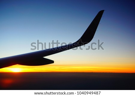 Silhouette Airplane on sky, Abstract Sunset Photo from Airplane, Sunset sky background, pictured from 
plane. Beautiful sky as twilight times, Space for text in template. 