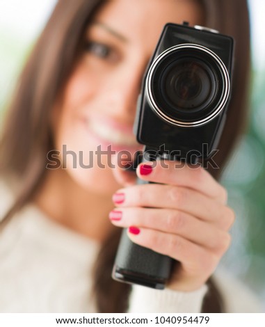 Portrait Of Woman Using Camcorder, Outdoors