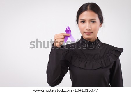 woman hand holding purple ribbon bow, lupus LSE or alzheimer awareness symbol; purple ribbon for medical, charity fund raising concept for lupus or alzheimer patient or prevention