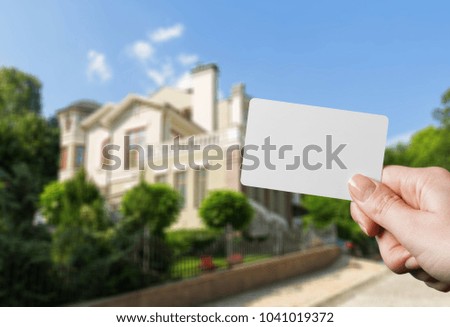 Hand holds white card