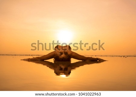 Silhouette of a young and fit woman on the beach