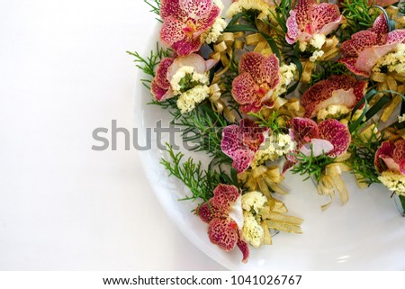 Boutonniere Flowers on chest for special guests. Placed in a white tray.