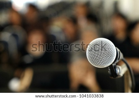 Silver microphone on the podium for those who will be the speakers at the conference. Royalty-Free Stock Photo #1041033838