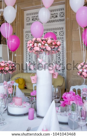 First birthday party of a baby concept made of white and pink colors balloons and candles
