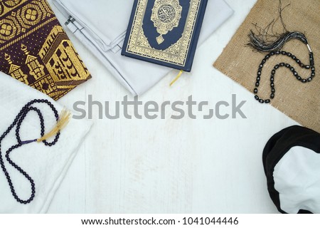 Ramadhan objects. Holy Quran, beautiful beads, prayer rugs, and moslem clothes. Royalty-Free Stock Photo #1041044446