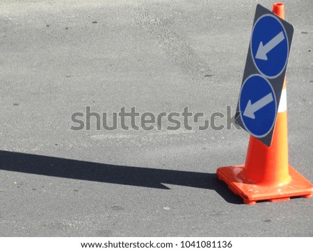 Directional arrow sign on orange traffic cone, Wellington New Zealand