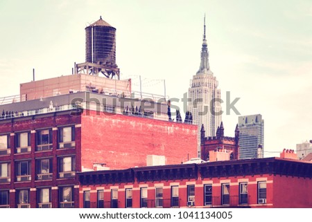 Retro toned picture of an old building with a water tank, one of New York City symbols, USA.