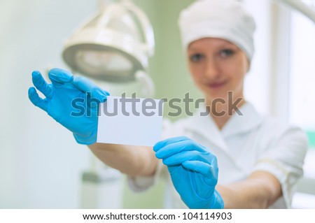Female doctor keeps a card in his hand
